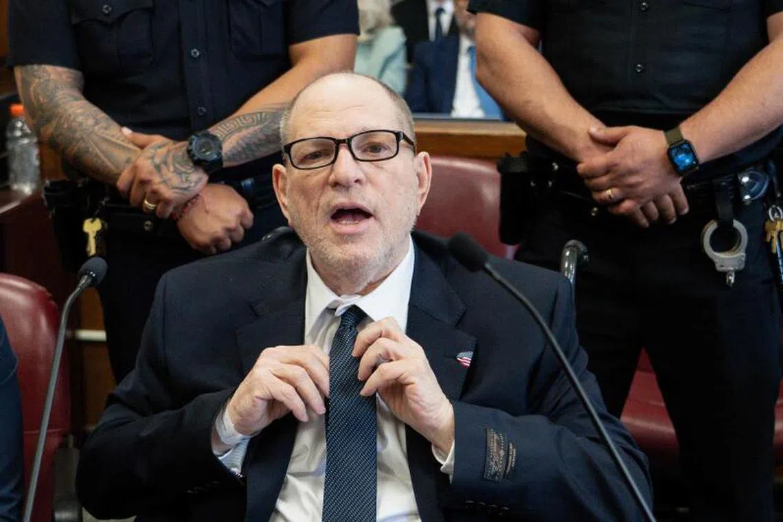 Disgraced Hollywood film producer Harvey Weinstein adjusts his tie as he appears in Manhattan Criminal Court ahead of opening arguments in the rape and sexual assault trial against him in New York on April 23, 2025.