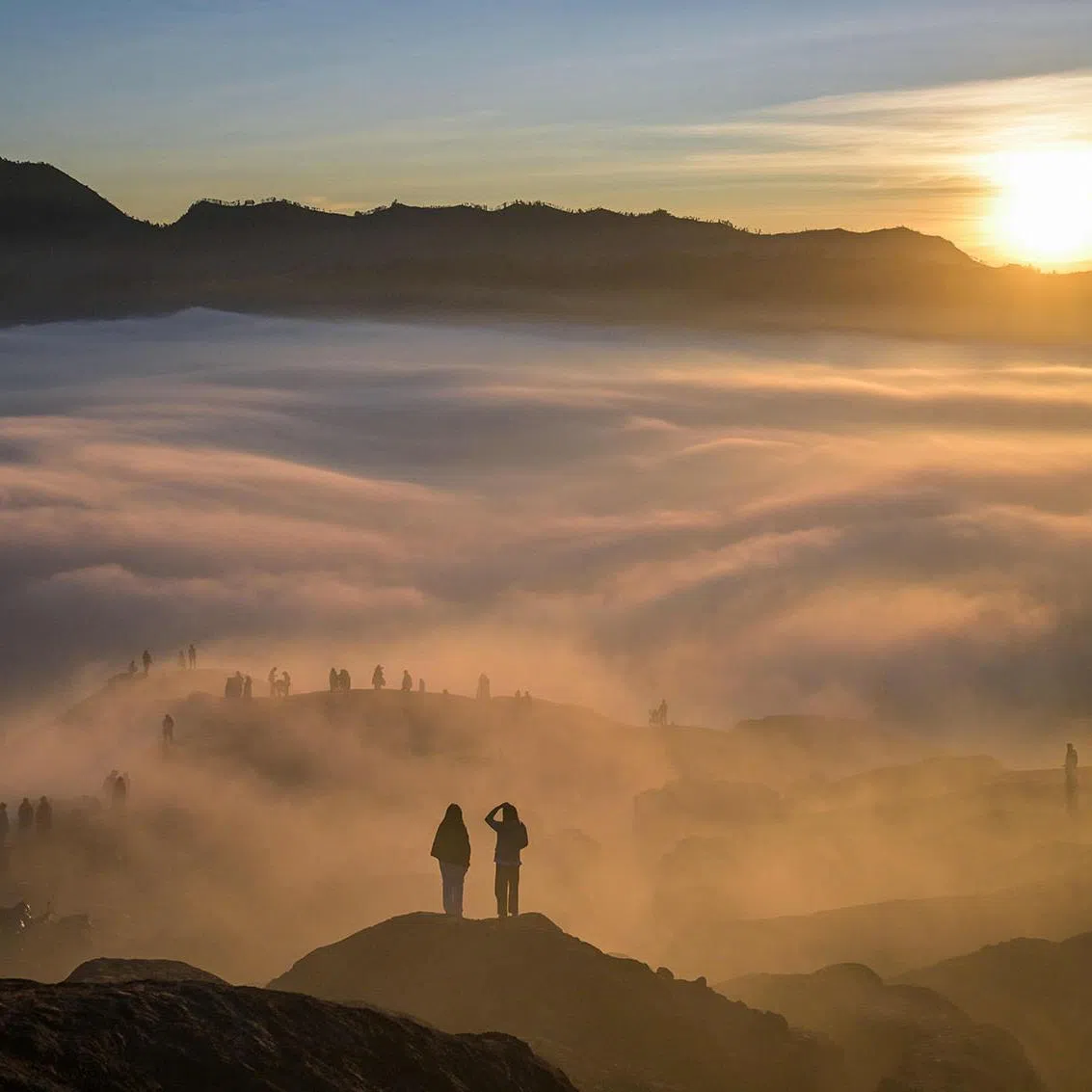 Hindu devotees of the Tengger community are seen through low-lying clouds during sunrise as they ascend the Mount Bromo volcano to present offerings of rice, fruit, livestock and other items as part of the Yadnya Kasada festival near Probolinggo, Indonesia's East Java province on June 1.