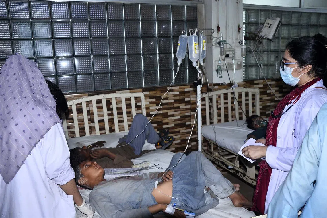 Students, who were injured after a seminary roof collapsed amid heavy rain, receiving treatment at a hospital in Hyderabad, Pakistan, on June 26.
