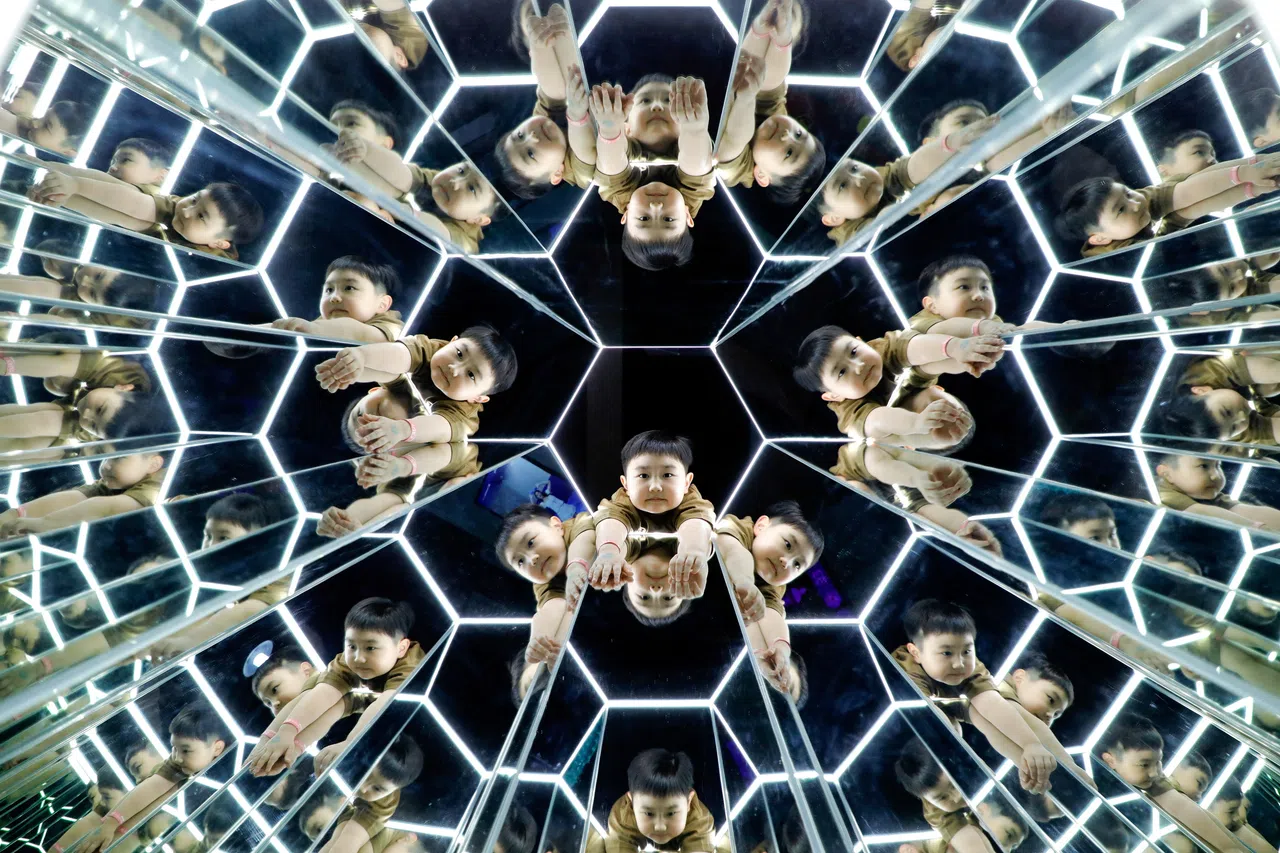A boy looks on while playing inside a space-themed immersive digital art installation "Space and Time Cube" in Surabaya, East Java province, Indonesia August 25, 2026. REUTERS/Dipta Wahyu     TPX IMAGES OF THE DAY