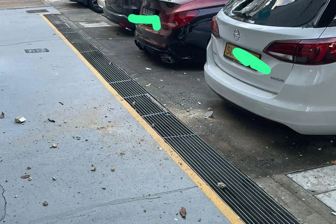 The spalling concrete damaged the rear windshield of a car parked nearby.