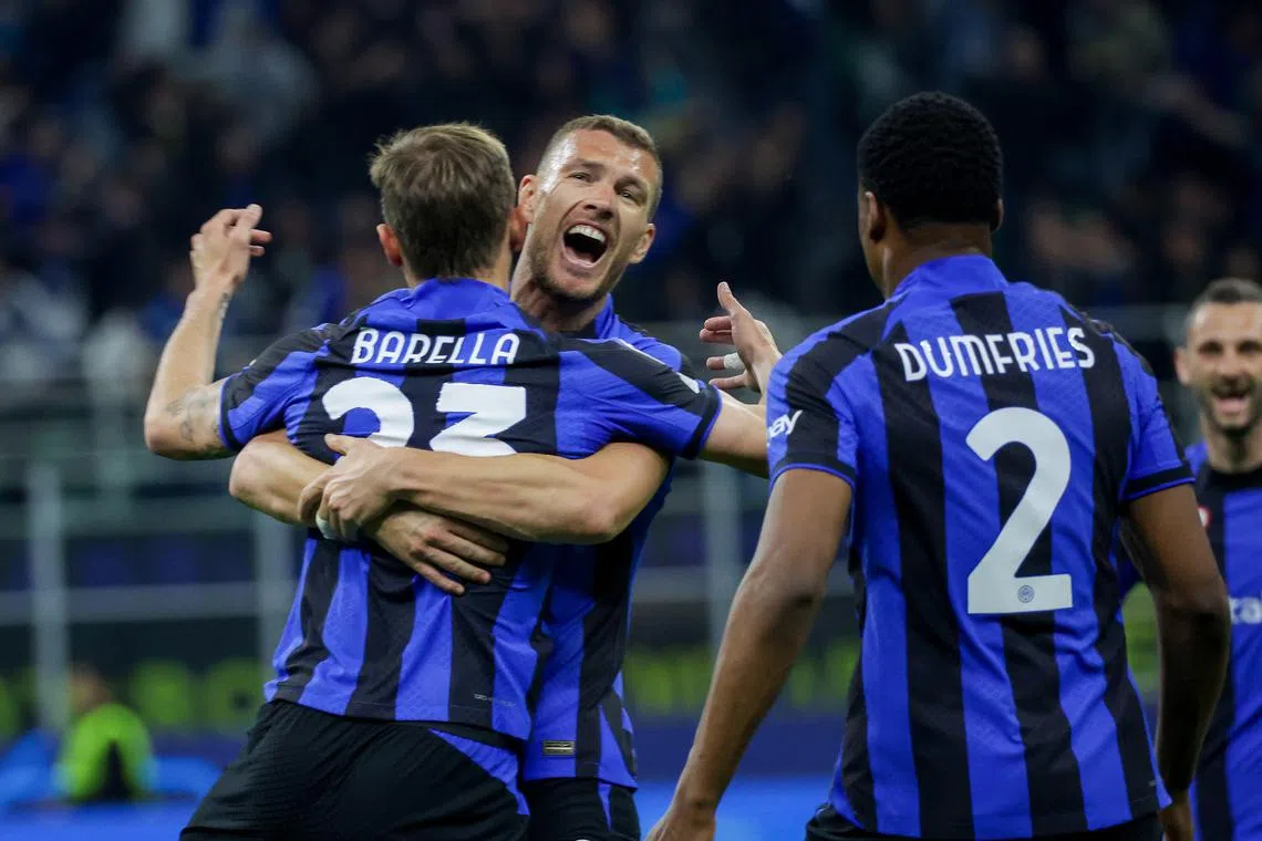 Inter Milan's midfielder Nicolo Barella celebrates with his teammates after scoring the 1-0 goal.