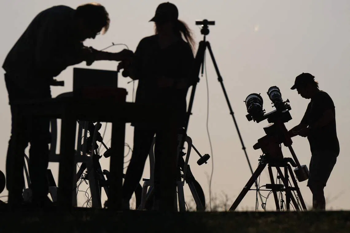 TOPSHOT - Researchers from San Francisco's Exploratorium museum carry out preparations for the global live broadcast of the upcoming August 12 total solar eclipse, in the abandoned village of Villalibado, near Burgos, northern Spain, on August 10, 2026. Around thirty scientists from the Exploratorium museum NASA's official partner for live astronomical coverage have set up three powerful telescopes in Villalibado to broadcast the eclipse live to 10 million people, choosing the village for its clear horizon, strong communications infrastructure, and location within the path of totality. (Photo by Cesar MANSO / AFP)