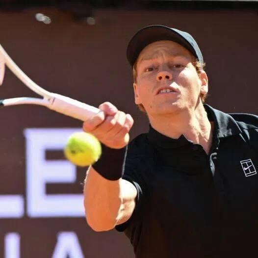 Italy's Jannik Sinner hits a return to Australia's Alexei Popyrin during the ATP Rome Open tennis tournament at Foro Italico in Rome on May 11, 2026.