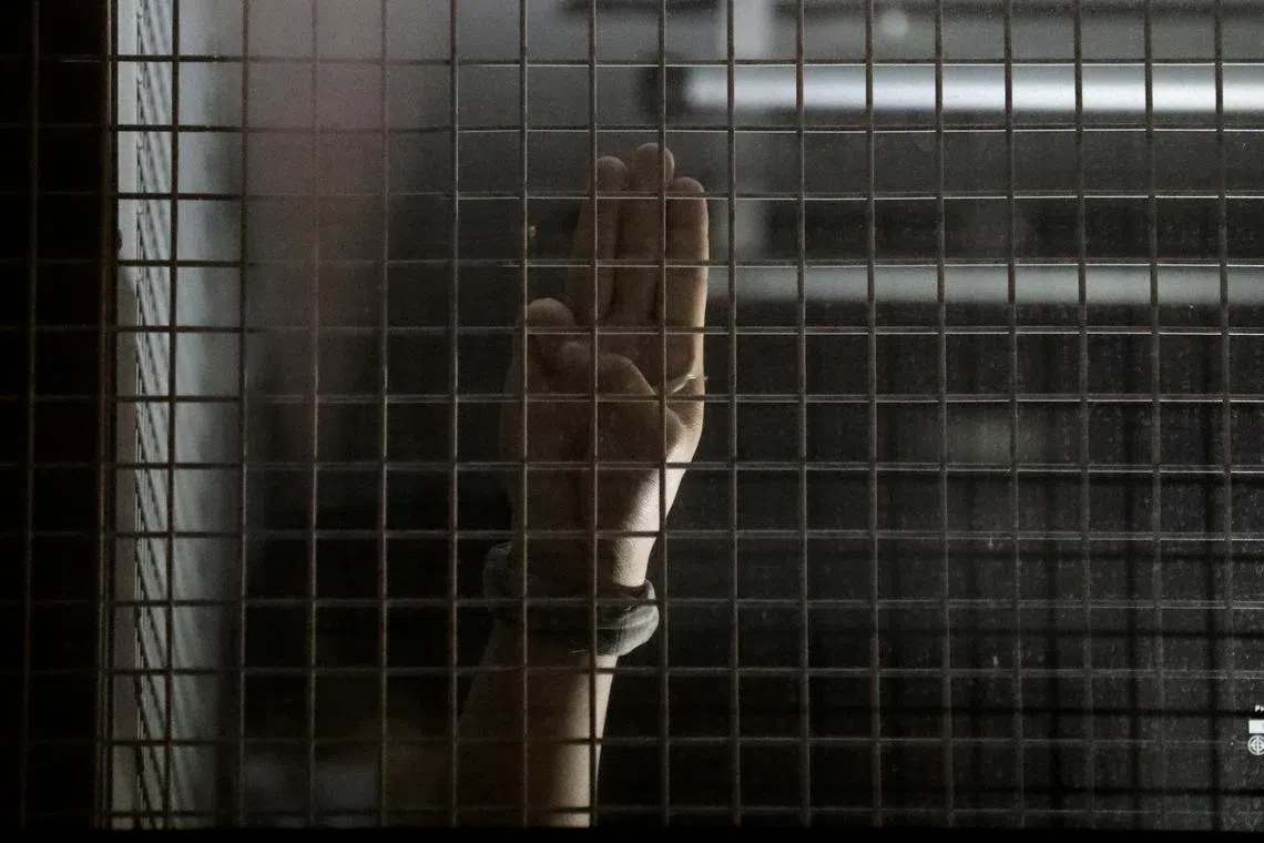 A detained protester gestures inside a prison vehicle in Bangkok, Thailand October 15, 2020. REUTERS/Soe Zeya Tun/File Photo