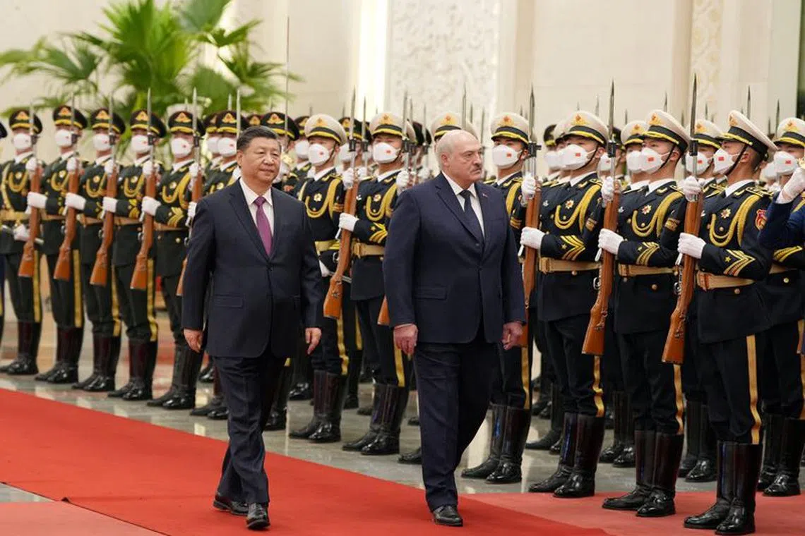 Chinese President Xi Jinping and Belarusian President Alexander Lukashenko review the honour guard during a welcome ceremony at the Great Hall of the People in Beijing, China March 1, 2023. cnsphoto via REUTERS/File photo