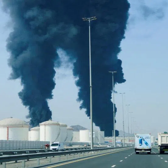 Smoke rising in the Fujairah oil industry zone, caused by debris after interception of a drone by air defences, on March 14, in Fujairah, United Arab Emirates.