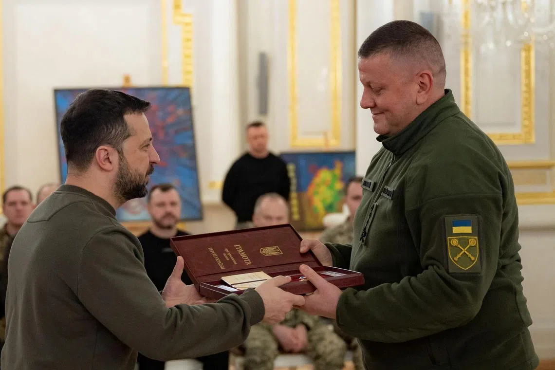 Ukrainian President Volodymyr Zelensky (left) awards former army chief Valeriy Zaluzhnyi the Hero of Ukraine Gold Star during a ceremony in Kyiv.