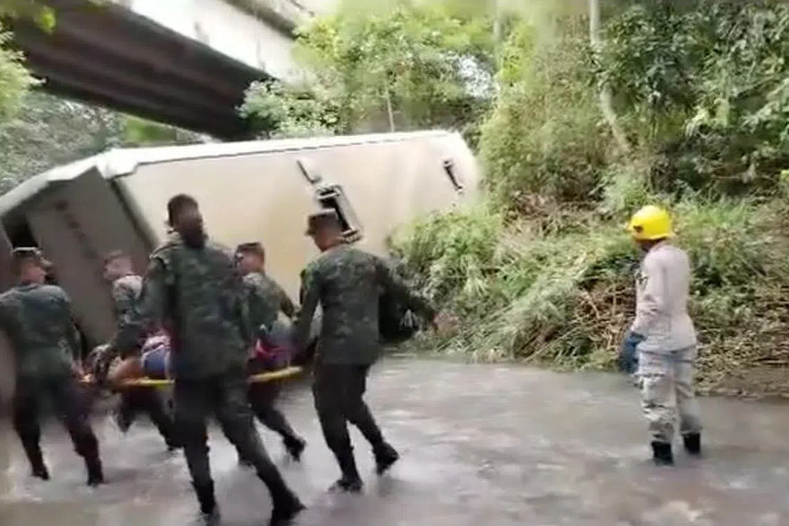 Soldiers carry a victim in stretcher, after a bus fell into a river near Tegucigalpa, in Honduras, December 5, 2023, in this screen grab taken from a video. Bomberos Honduras/Handout via REUTERS