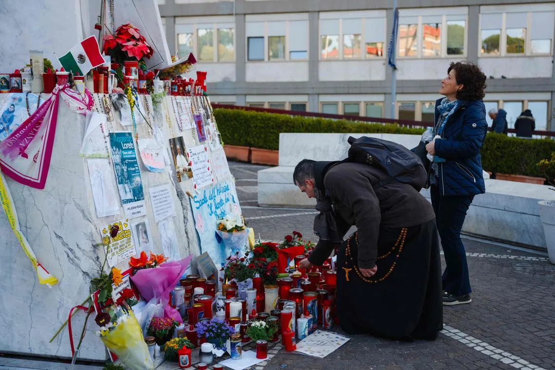 Candles and messages for Pope Francis placed outside Rome's Gemelli University Hospital where the pontiff is hospitalised.