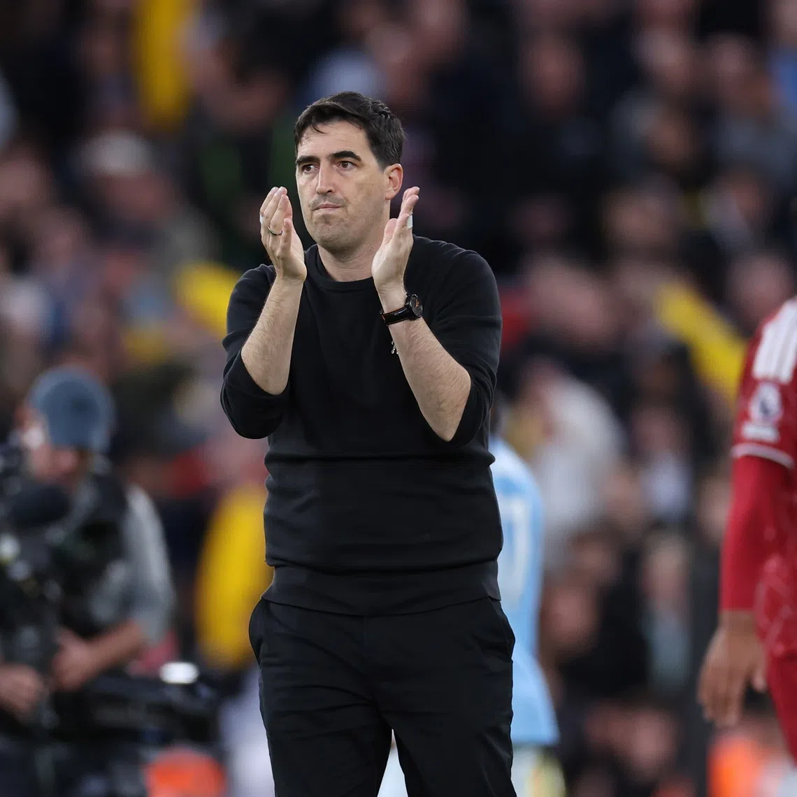 Liverpool manager Andoni Iraola applauds the supporters after his side’s 3-0 defeat to Manchester City, in Liverpool, Britain, on Oct 11.