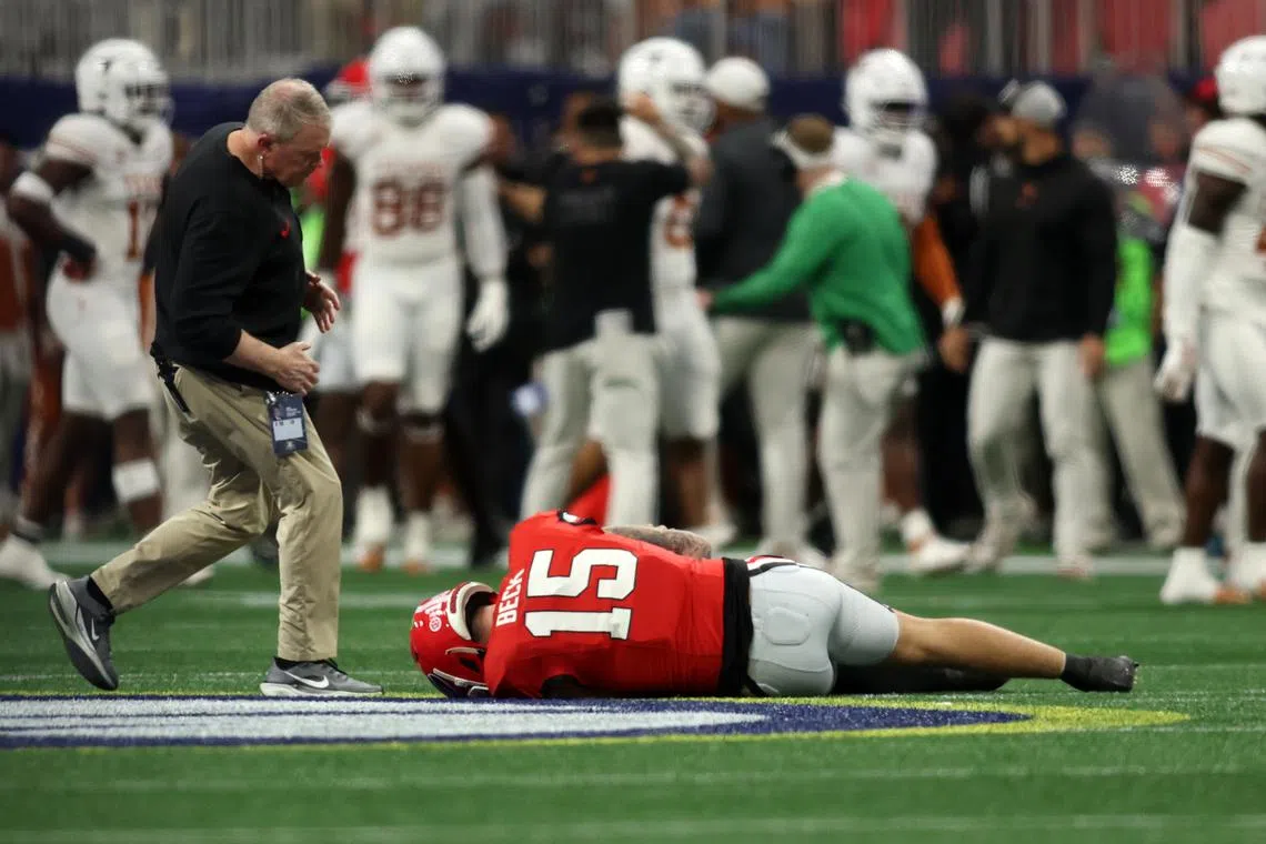 FILE PHOTO: Dec 7, 2024; Atlanta, GA, USA; Georgia Bulldogs quarterback Carson Beck (15) is injured on a play against the Texas Longhorns during the first half in the 2024 SEC Championship game at Mercedes-Benz Stadium. Mandatory Credit: Brett Davis-Imagn Images/File photo
