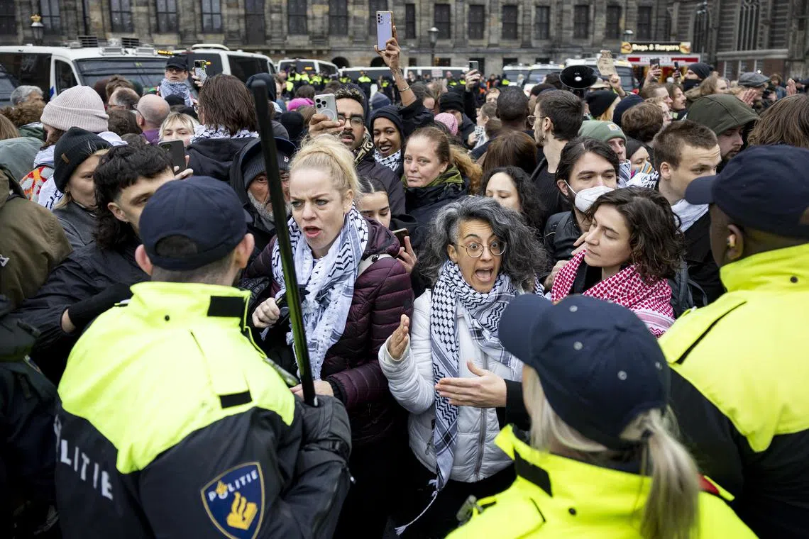 Pro-Palestinian protesters face Dutch police on Dam Square in Amsterdam on Nov 10.