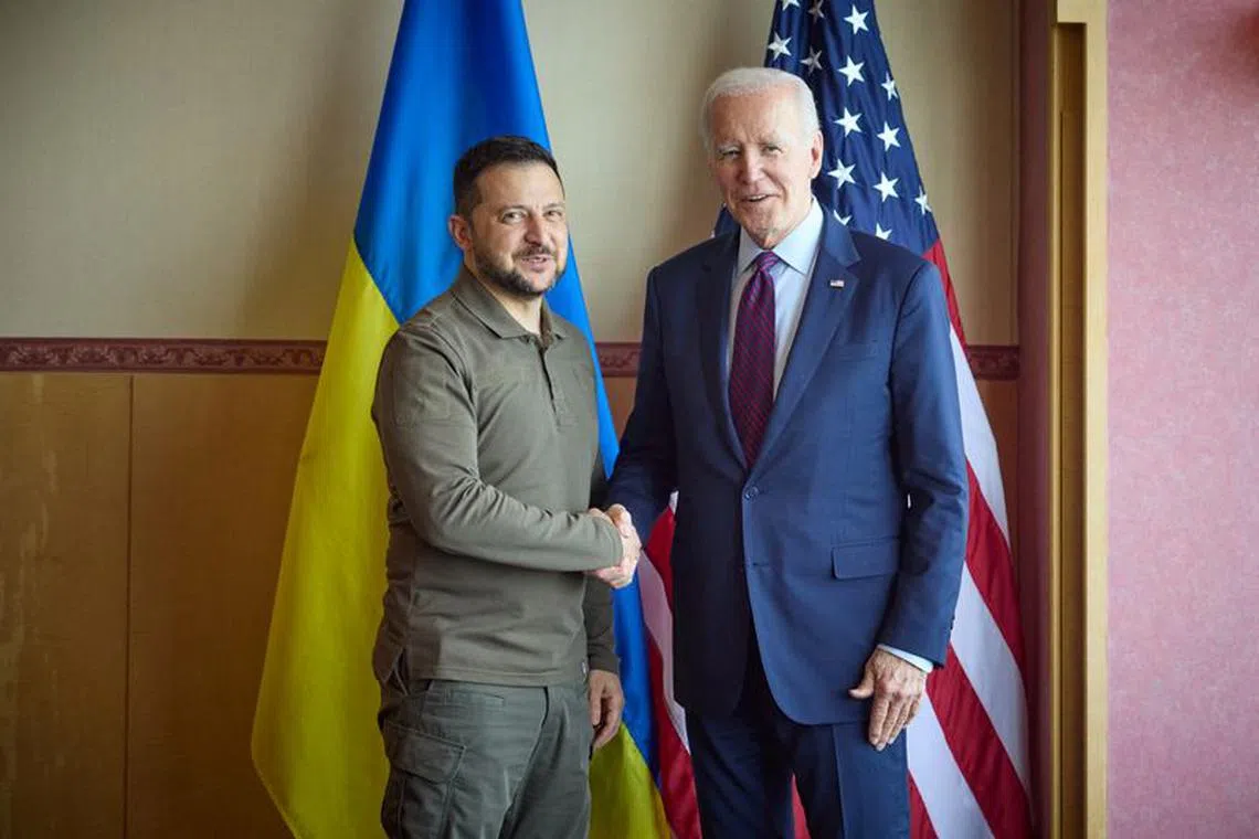 Ukraine's President Volodymyr Zelenskiy and U.S. President Joe Biden shake hands during the G7 leaders' summit in Hiroshima, Japan May 21, 2023. Ukrainian Presidential Press Service/Handout via REUTERS/file photo