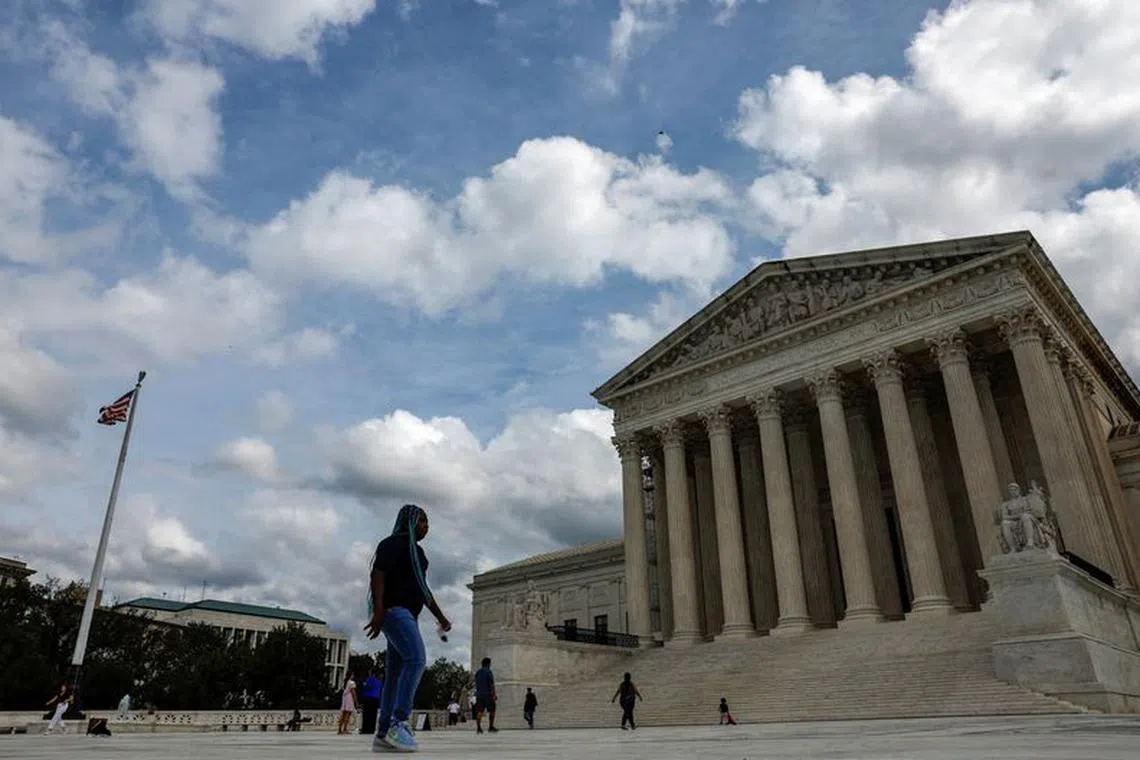 FILE PHOTO: Visitors walk in front of the United States Supreme Court building in Washington, U.S., September 22, 2023. REUTERS/Evelyn Hockstein/File Photo