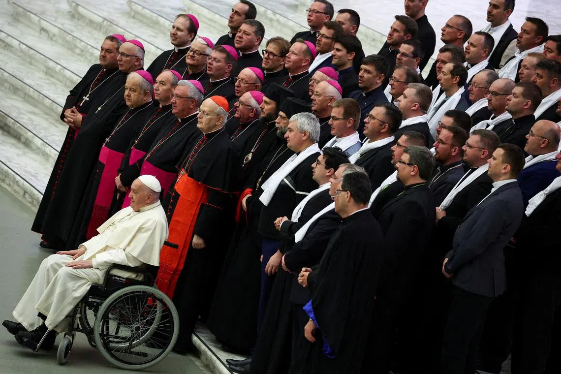 Pope Francis posing for a photograph with pilgrims from Hungary in Paul VI Hall, at the Vatican, on April 25, 2024. 