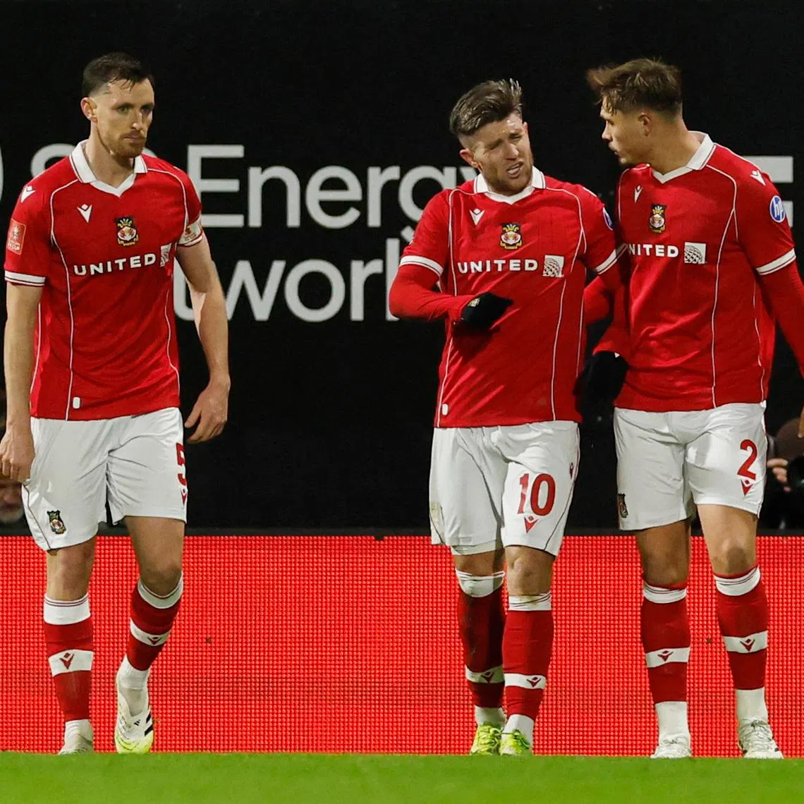 Soccer Football -  FA Cup - Fourth Round - Wrexham v Ipswich Town  - SToK Racecourse, Wrexham, Wales, Britain - February 13, 2026 Wrexham's Josh Windass celebrates scoring their first goal with Wrexham's Callum Doyle Action Images via Reuters/Jason Cairnduff