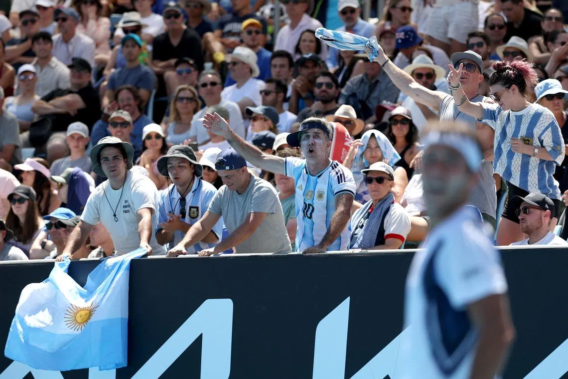 Tennis - Australian Open - Melbourne Park, Melbourne, Australia - January 18, 2026 Fans of Argentina's Tomas Martin Etcheverry react during his first round match against Serbia's Miomir Kecmanovic REUTERS/Edgar Su