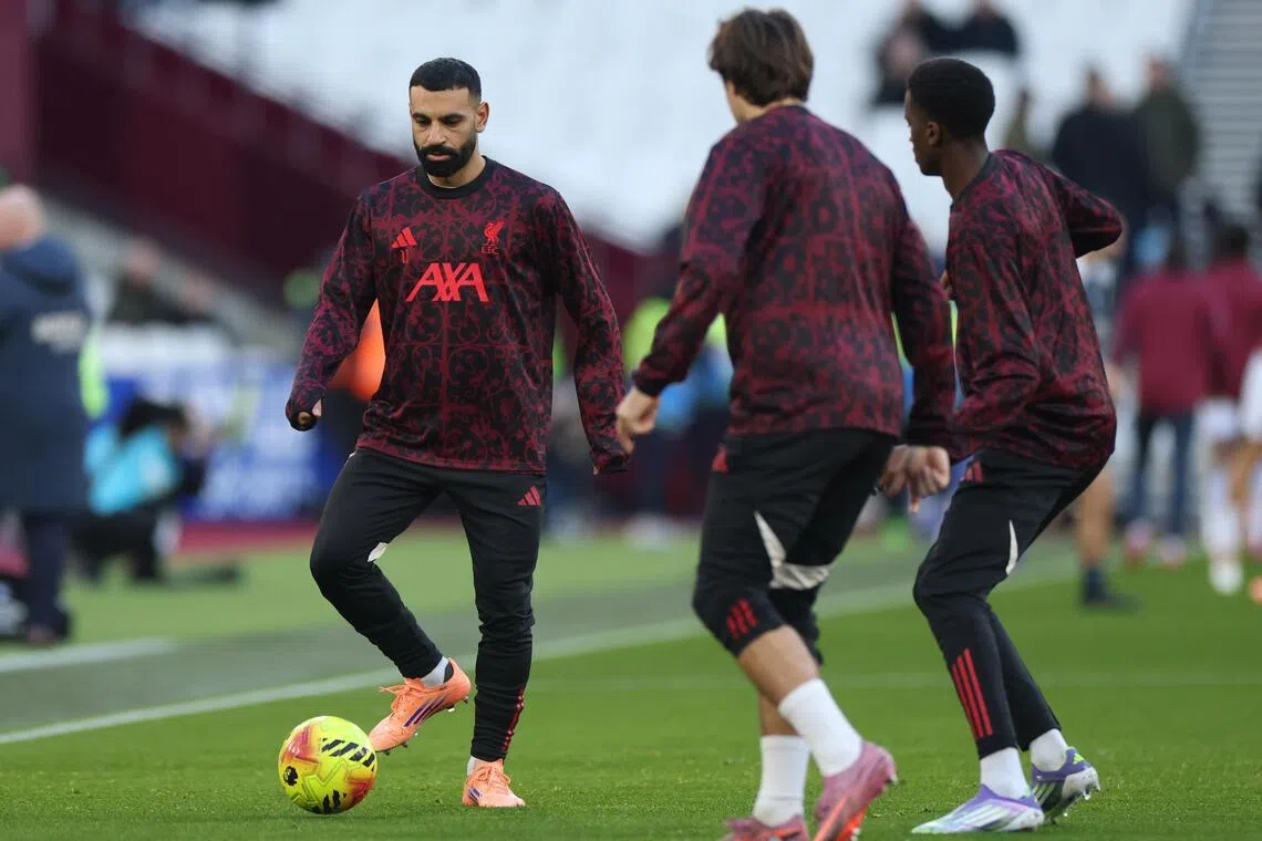 Liverpool's Mohamed Salah (left) warming up ahead of their Nov 30 match against West Ham. Salah was omitted from the match.
