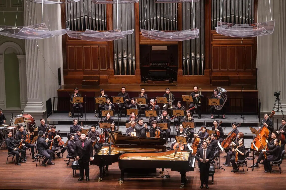Pianists Nicholas Loh (left) and Jonathan Shin (right), with the re:Sound orchestra conducted by Adrian Chiang.