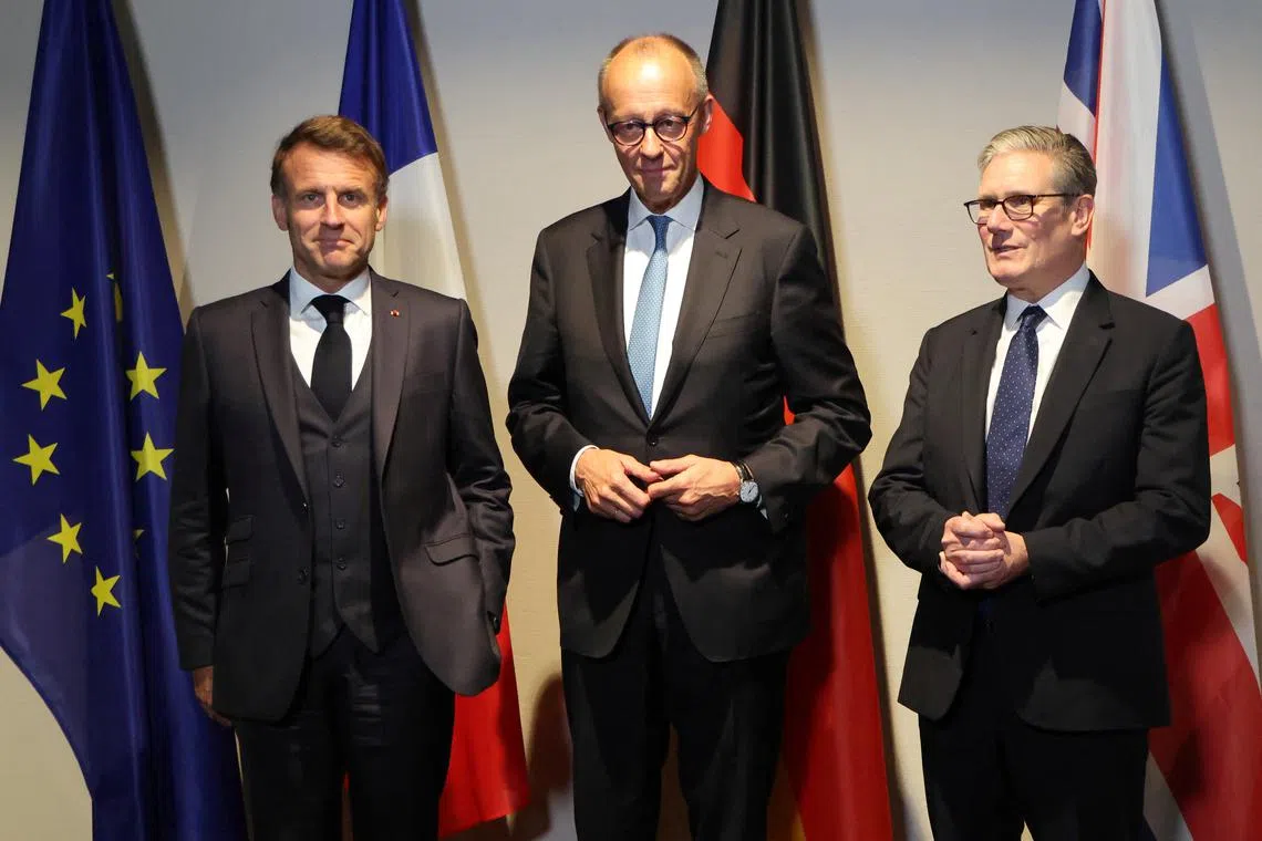 FILE PHOTO: France's President Emmanuel Macron, Germany?s Chancellor Friedrich Merz and Britain's Prime Minister Keir Starmer pose as they meet on the sidelines of the two-day NATO's Heads of State and Government summit, in The Hague, Netherlands June 24, 2025. Ludovic Marin/Pool via REUTERS/File Photo