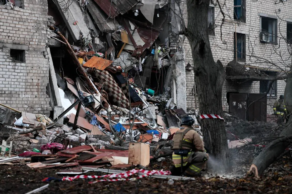 Ukrainian rescuers working at the site of a Russian strike on a residential area in Zaporizhzhia, southeastern Ukraine, on Oct 30.
