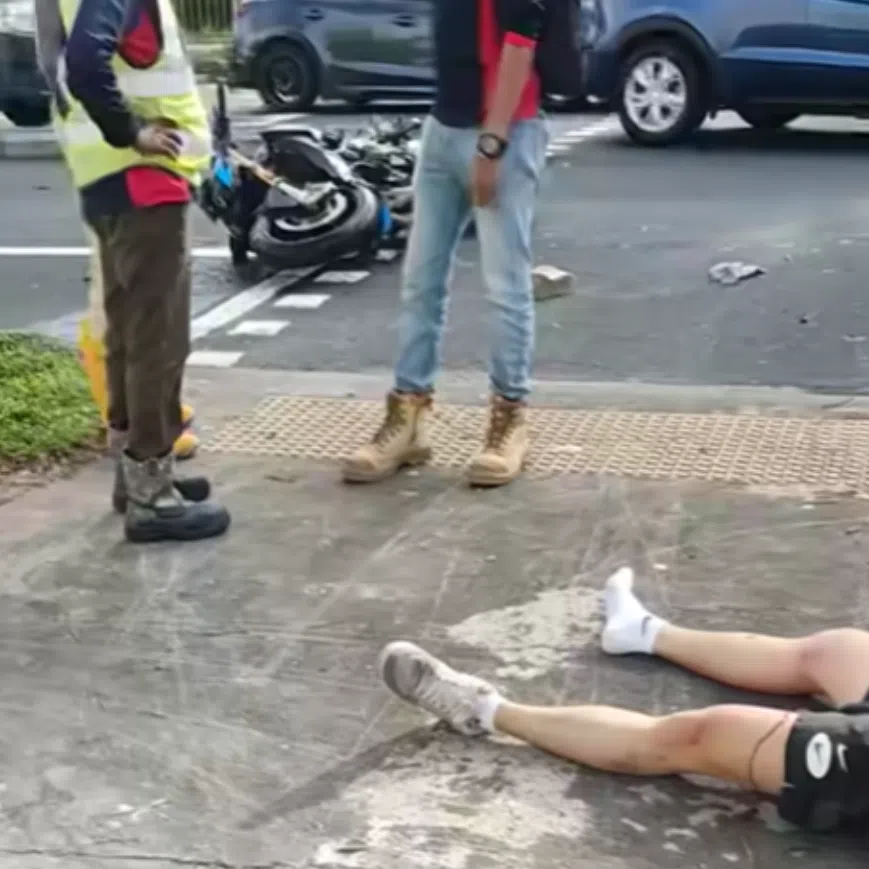 A man wearing a motorcyclist helmet is seen lying on a pavement nearby in a video of the accident uploaded online.