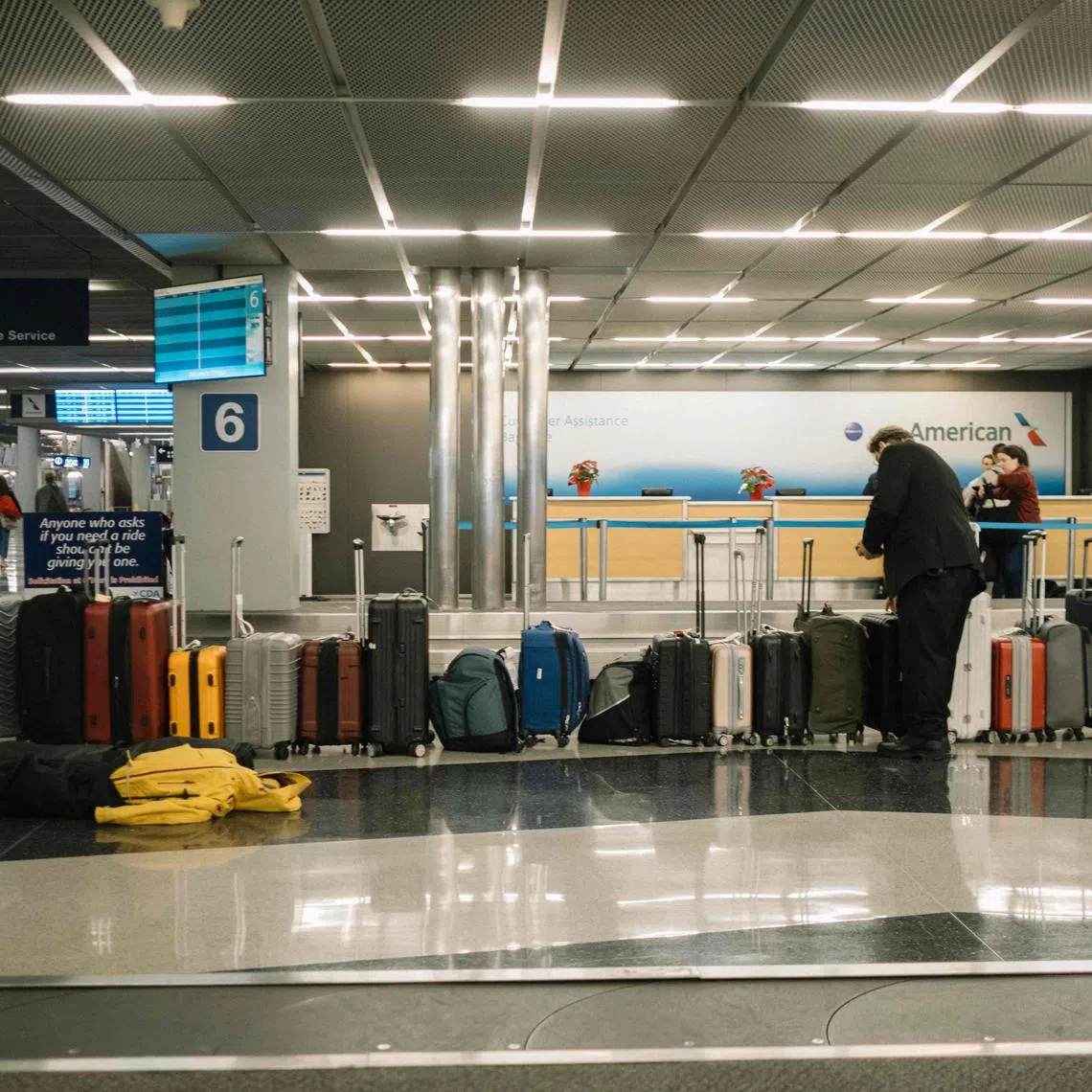 CHICAGO, ILLINOIS - JANUARY 12: A worker collects and scans unclaimed luggage at O'Hare Airport on January 12, 2024 in Chicago, Illinois. Over 1,900 flights have been canceled nationwide due to a large winter storm bringing blizzard conditions.   Jim Vondruska/Getty Images/AFP (Photo by Jim Vondruska / GETTY IMAGES NORTH AMERICA / Getty Images via AFP)