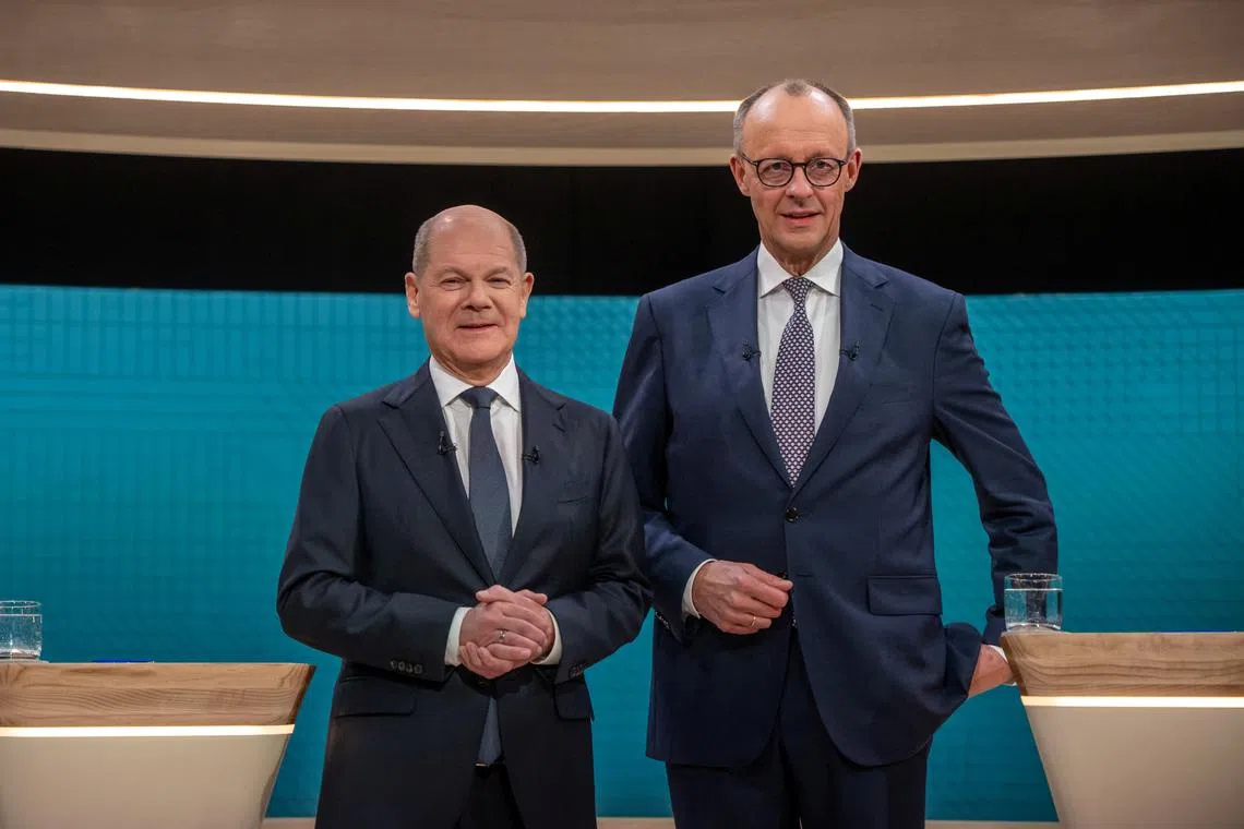 German Chancellor Olaf Scholz (left) and his conservative election rival Friedrich Merz during a pre-election TV debate in Berlin, on Feb 9.
