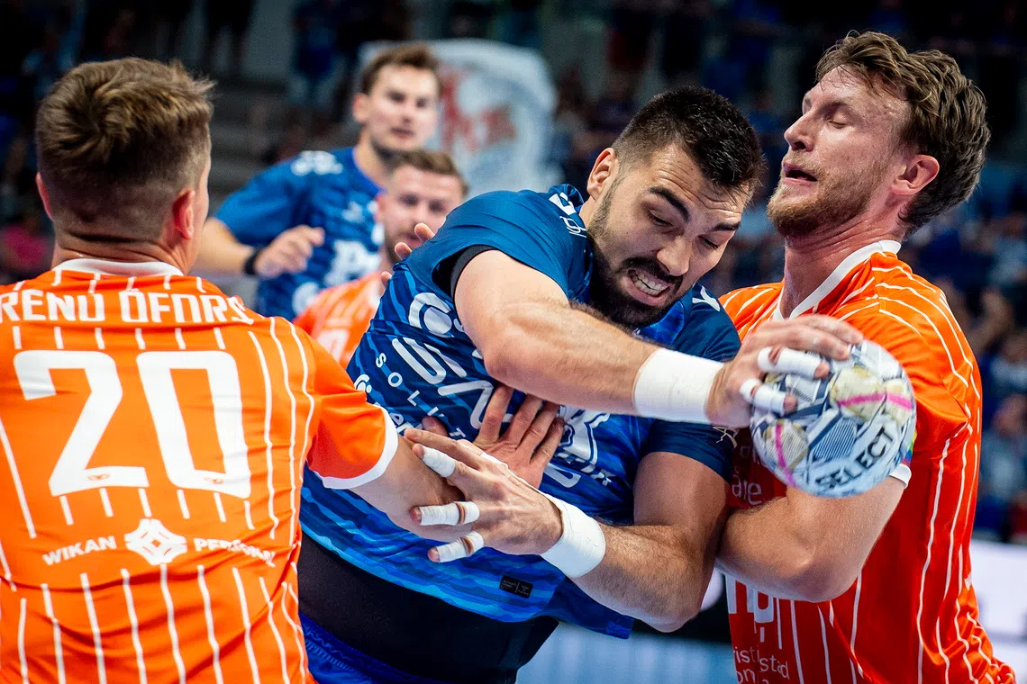 epa13229242 Miklos Rosta (C) of Szeged in action against Emil Frend Oefors (L) and Philipp Henningsson of Kristianstad during the handball EHF Champions League match between OTP Bank-Pick Szeged and IFK Kristianstad, in Szeged, Hungary, 10 September 2026. EPA/Sandor Ujvari HUNGARY OUT