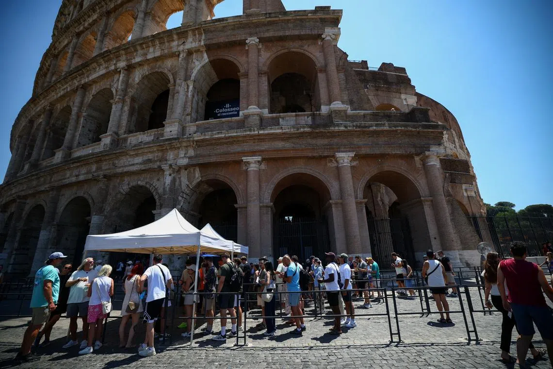 Tourists queueing under the sun outside the Colosseum during hot weather in Rome, Italy, on June 20.