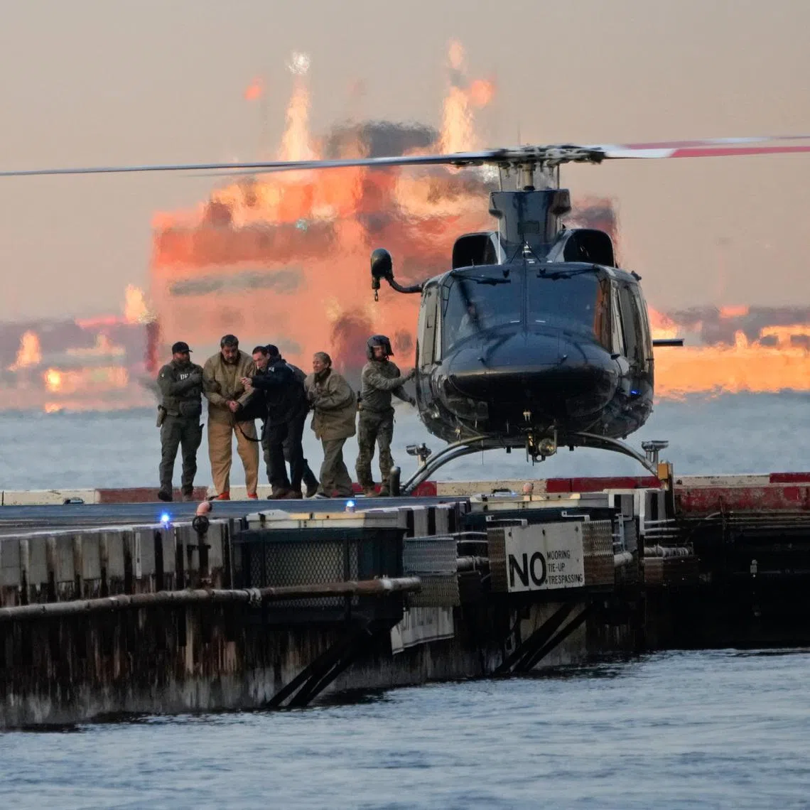 Venezuela’s ousted president Nicolas Maduro and his wife, Cilia Flores, are escorted off a helicopter en route to the federal courthouse in Manhattan on Jan 5.