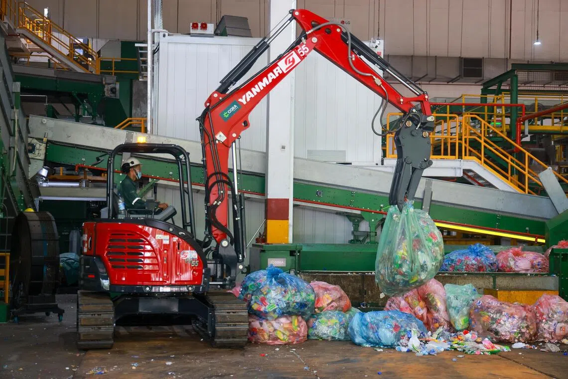 The bags are coloured red, blue and green, based on the regions they were collected from. Red bags come from reverse vending machines in the west.