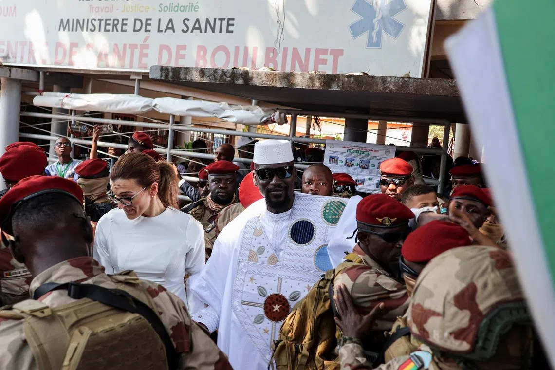 Guinean leader Mamadi Doumbouya arrives with his wife, Lauriane Darboux Doumbouya, to cast his vote during the presidential election at a polling station in Conakry, Guinea, December 28, 2025. REUTERS/ Souleymane Camar
