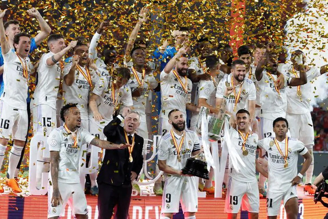 FILE PHOTO: Soccer Football - Copa del Rey - Final - Real Madrid v Osasuna - Estadio de La Cartuja, Seville, Spain - May 7, 2023 Real Madrid's Karim Benzema celebrates with the trophy and team mates after winning the Copa del Rey REUTERS/Jon Nazca/File Photo