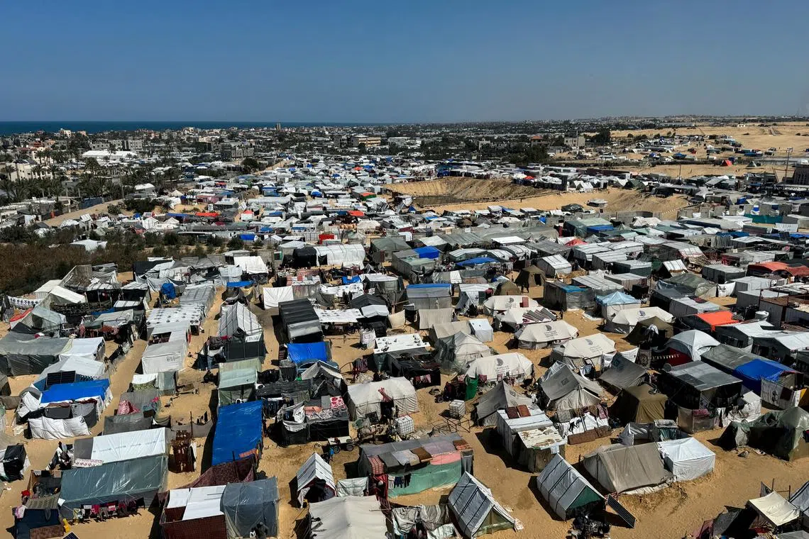 FILE PHOTO: Displaced Palestinians, who fled their houses due to Israeli strikes, shelter in a tent camp, amid the ongoing conflict between Israel and the Palestinian Islamist group Hamas, in Rafah, in the southern Gaza Strip March 11, 2024. REUTERS/ Bassam Masoud/File Photo