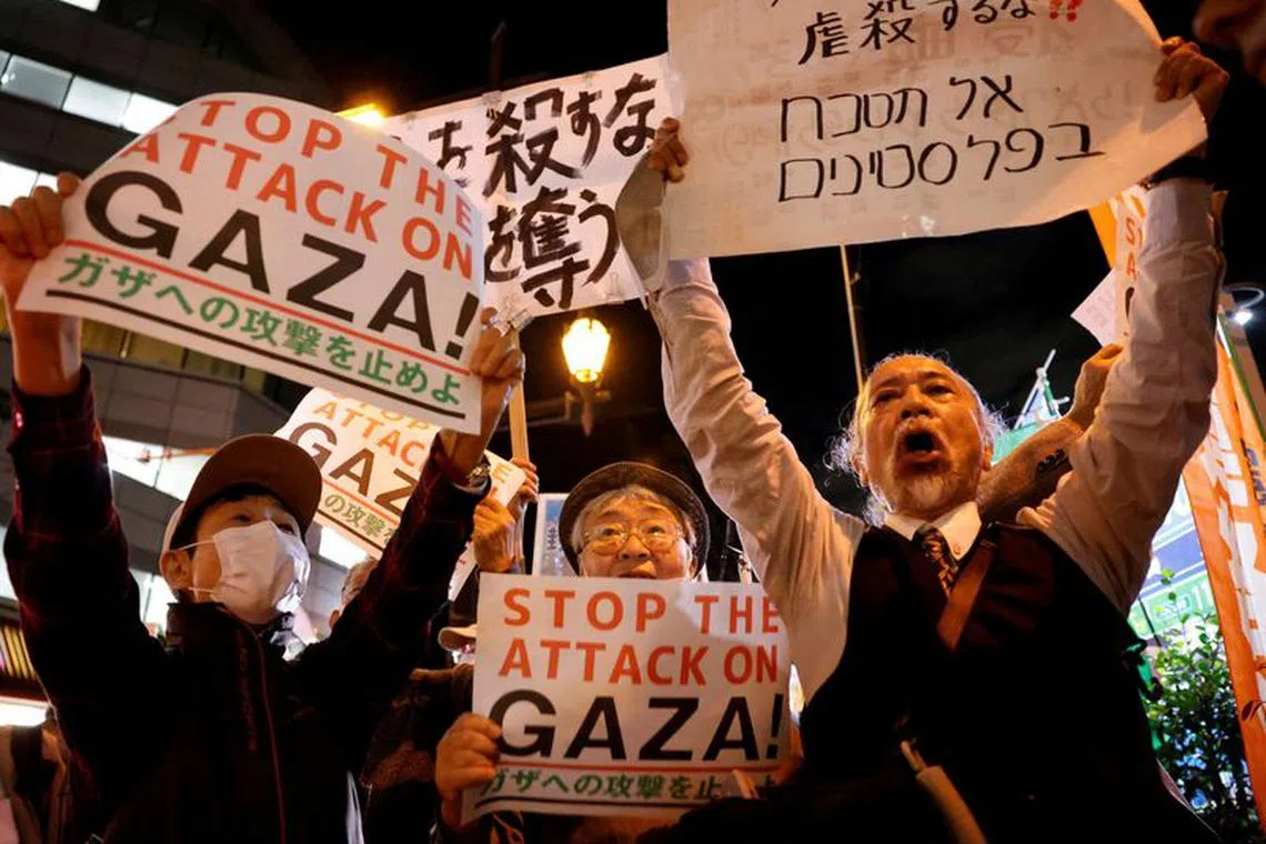 People hold a rally to protest against Israel's attack on Gaza near the Israeli embassy in Tokyo, Japan October 16, 2023.  REUTERS/Issei Kato/File Photo