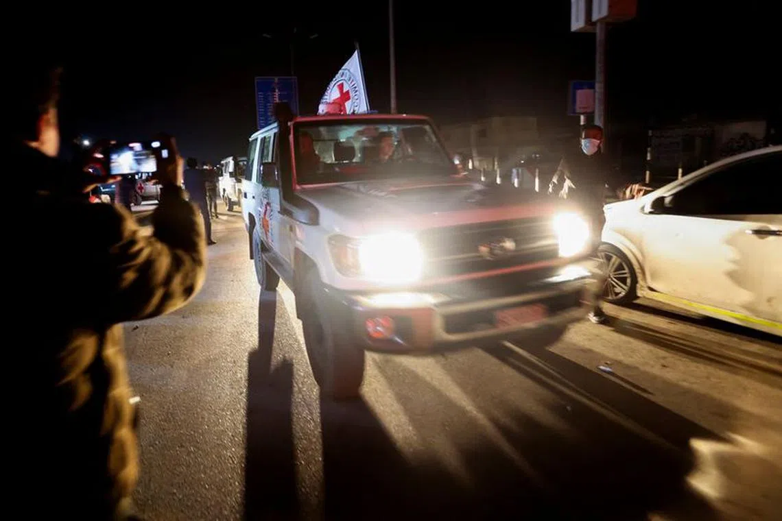 FILE PHOTO: A Red Cross vehicle, as part of a convoy carrying hostages abducted by Hamas militants during the October 7 attack on Israel, arrives at the Rafah border, amid a hostages-prisoners swap deal between Hamas and Israel, in the southern Gaza Strip, November 30, 2023. REUTERS/Ibraheem Abu Mustafa/File Photo