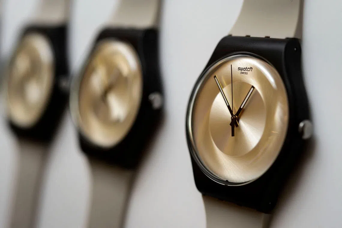 (FILES) Models of the Swatch brand Swiss watches are displayed during a press conference in Biel on March 10, 2016. Swatch Group said July 17, 2025, that weak sales in China wiped out growth elsewhere in the first half of the year for the world's top watch company, leaving it barely profitable. Net sales fell 11.2 percent to 3.1 billion Swiss francs (USD 3.8 billion), while net profit plunged 88 percent to 17 million francs. (Photo by FABRICE COFFRINI / AFP)