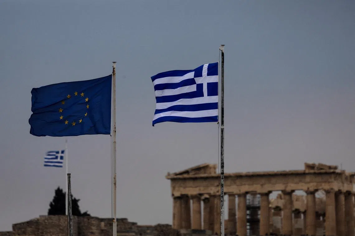 FILE PHOTO: A European Union and the Greek flags flutter, with the Parthenon temple atop the Acropolis hill seen in the background in Athens, Greece, April 9, 2025. REUTERS/Alkis Konstantinidis/ File Photo