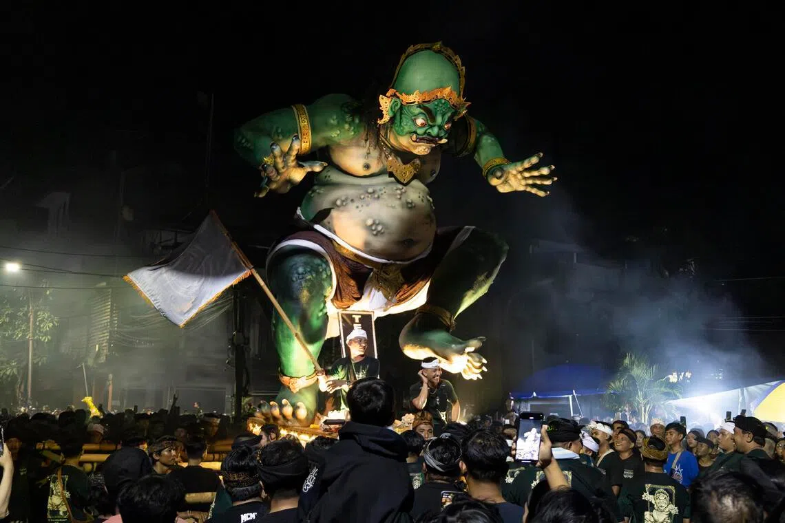 Balinese carry giant effigies depicting aspects of evil during a parade before Nyepi Day, the Balinese Day of Silence, in Denpasar, Bali, Indonesia, on March 18. 