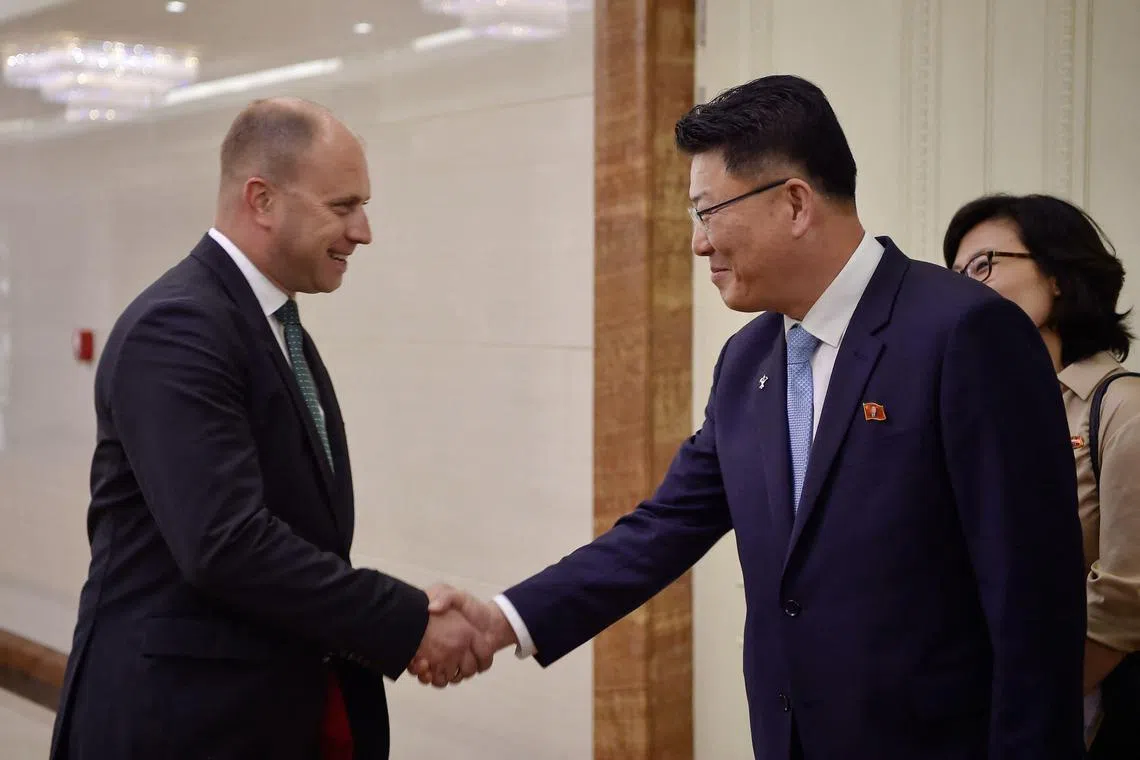 Russian Deputy Industry and Trade Minister Roman Chekushov (left), is greeted by North Korea’s External Economic Relations Minister Yun Jong Ho.