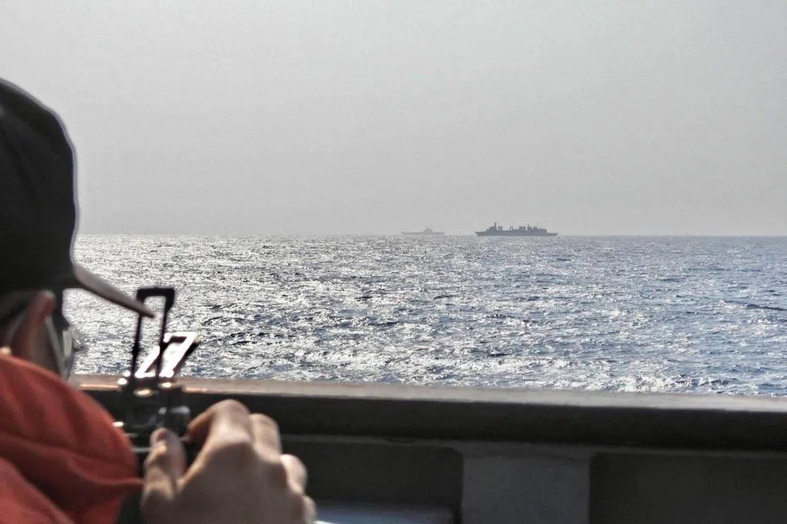 A crew member is photographed aboard a Taiwanese navy ship while monitoring the aircraft carrier fleet of Chinese PLA Navy.