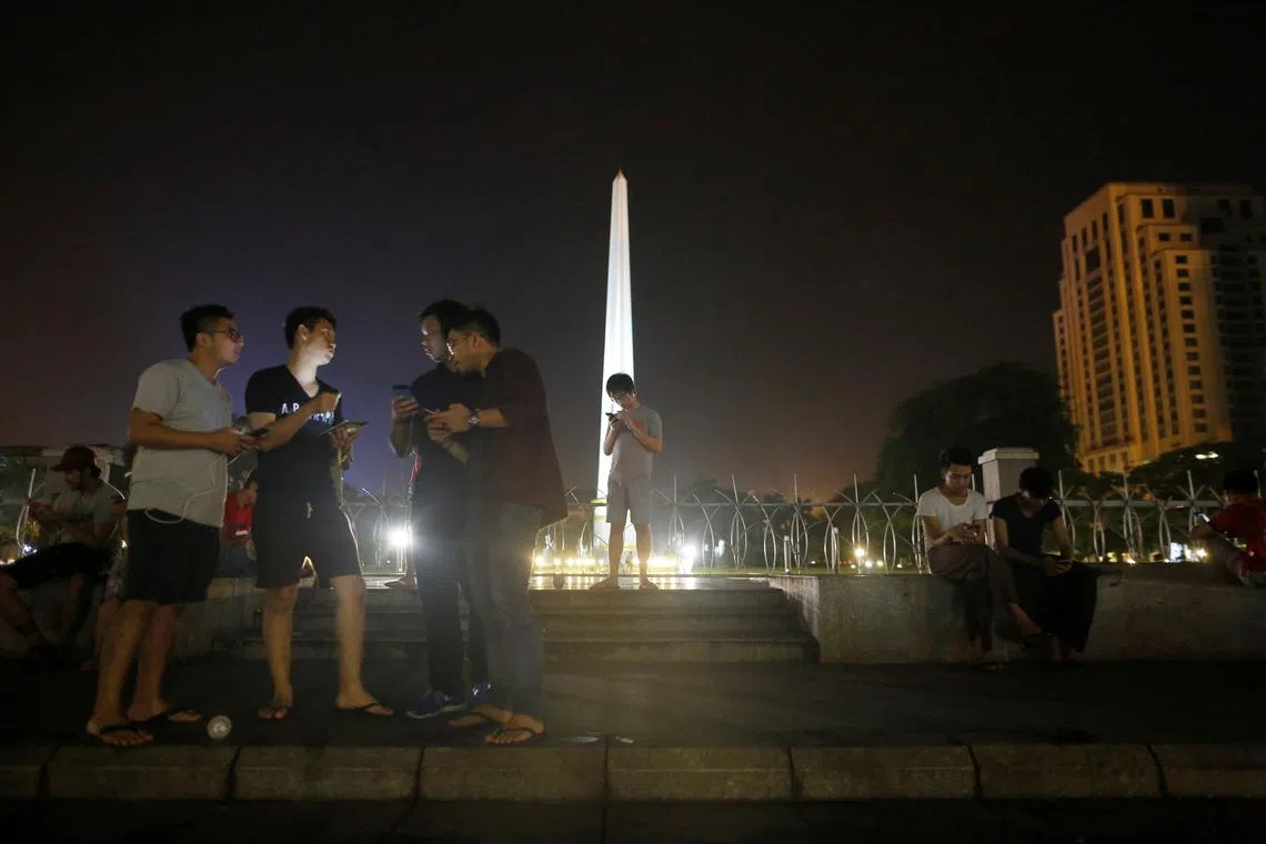 FILE PHOTO: Youths play Pokemon Go in front of City Hall in central Yangon, Myanmar, August 11, 2016. REUTERS/Soe Zeya Tun/File Photo