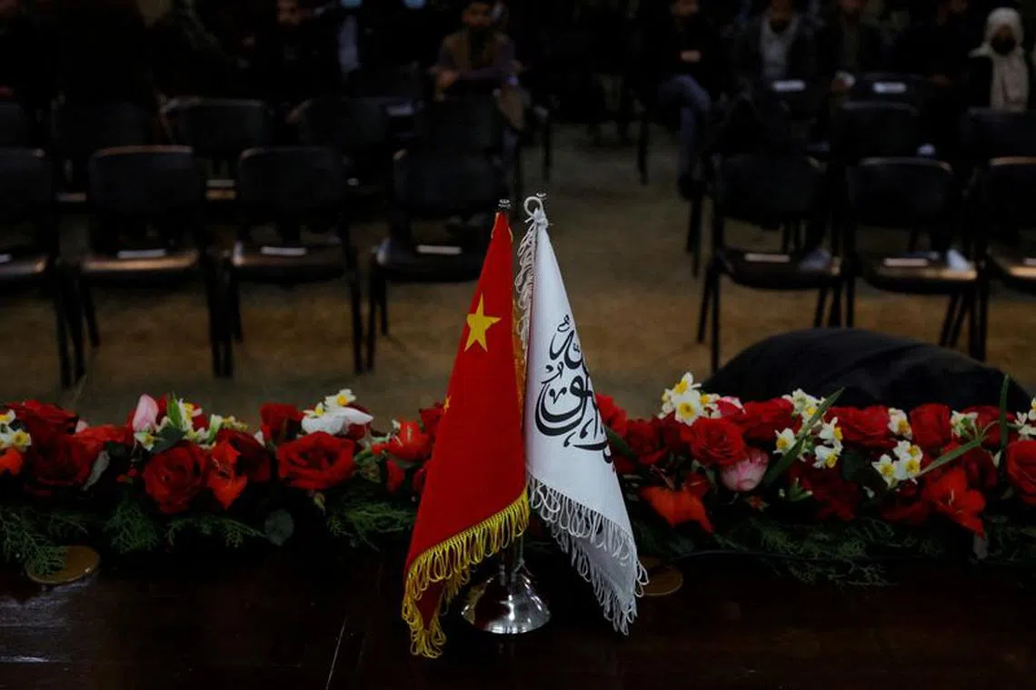FILE PHOTO: The flags of the China and the Islamic Emirate of Afghanistan are displayed during a news conference held by Afghan Deputy Prime Minister Mullah Abdul Ghani Baradar and Wang Yu, China's ambassador in Afghanistan, in Kabul, Afghanistan, January 5, 2023. REUTERS/Ali Khara/File Photo