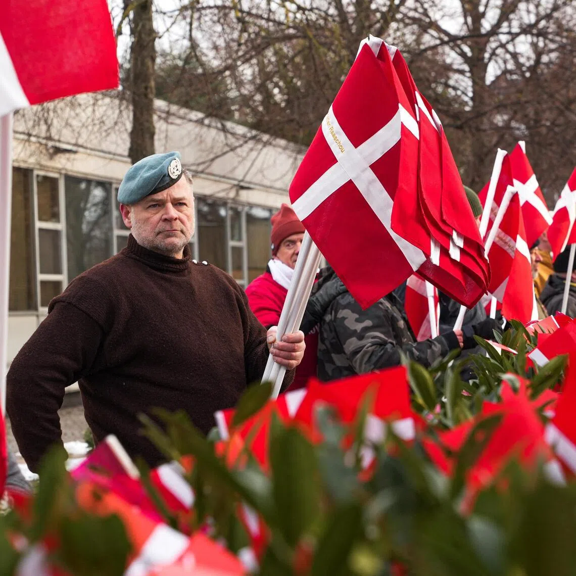 Protesters and veterans on Jan 31 planted Danish flags embroidered with the names of soldiers who died in Afghanistan and Iraq outside the US embassy in Copenhagen.