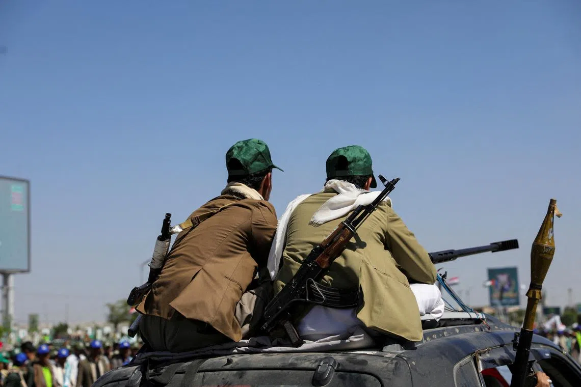 FILE PHOTO: Houthi-mobilized fighters ride atop a car in Sanaa, Yemen September 21, 2024. REUTERS/Khaled Abdullah/File Photo
