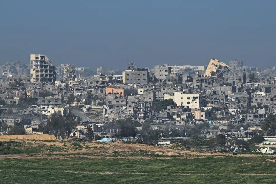 Buildings lie in ruin in Gaza, amid the ongoing conflict between Israel and the Palestinian Islamist group Hamas, as seen from Israel, February 13, 2024. REUTERS/Dylan Martinez