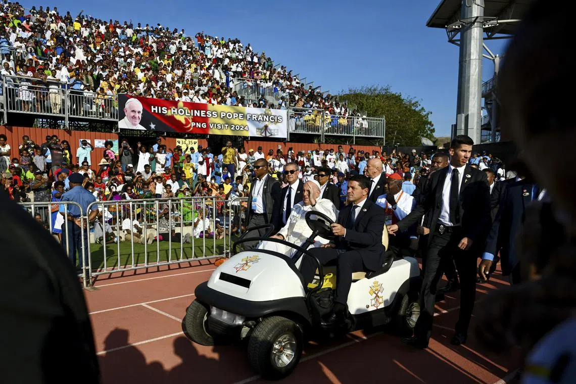 Pope Francis (centre) arrives to lead a Sunday mass at the Sir John Guise Stadium in Port Moresby, Papua New Guinea, on Sept 8. 