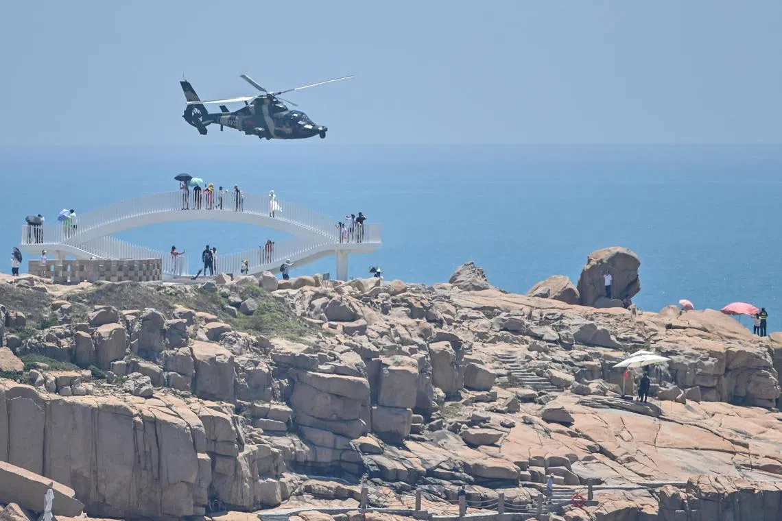 A Chinese military helicopter flies past Pingtan island, one of China's closest point from Taiwan, in Fujian, on Aug 4, 2022.